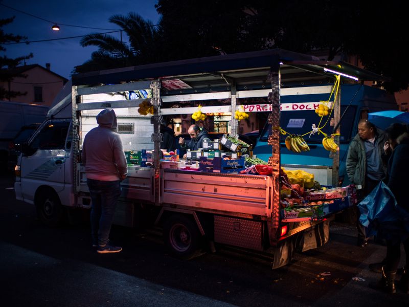 A truck selling fruit and vegetables on the street